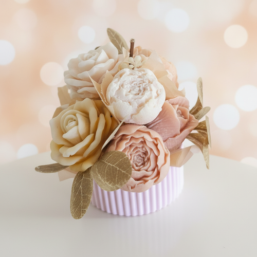 Blush and cream wax melt bouquet with roses and peonies on a warm peach background